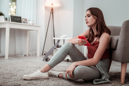 New music app. A woman in earphones listening to the musicの写真素材