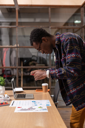Copying documents. A man taking pictures of paper documents using a smartphoneの写真素材
