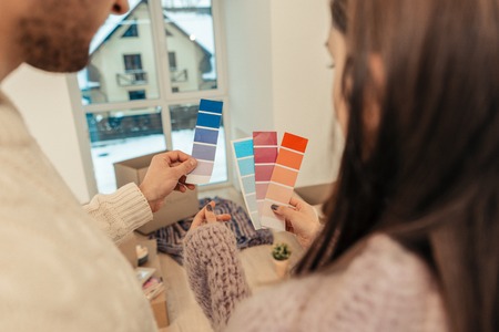 Colors for apartment. Close up of couple choosing colors for apartment while making renovationの写真素材