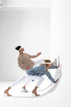 Gravity photo session. Professional stylish models wearing blindfolds posing for creative gravity photo sessionの写真素材