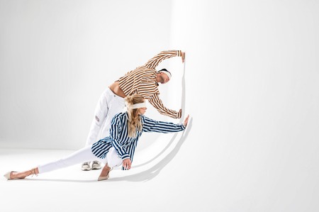 Nice poses. Models wearing white trousers and striped shirts and blindfolds showing nice posesの写真素材