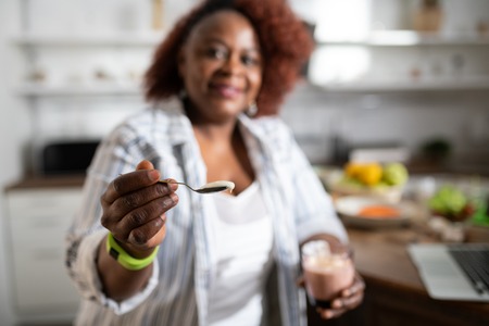 Try it. Silhouette of cheerful woman that keeping smile on her face while posing on cameraの写真素材
