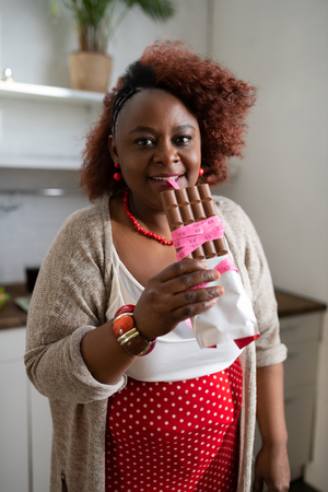 On diet. Delighted female person being in the kitchen and posing on cameraの写真素材