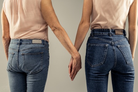 Always together. Close up of mother and daughters hands while being held togetherの写真素材