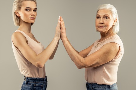 Pleasant food looking women standing together while showing the connection between them