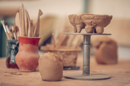 Masterful handwork. Clay bowls standing on the special stand while being shown to youの写真素材