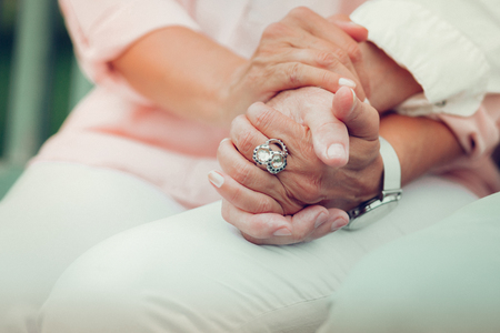 Married couple. Close up of hands of a nice married couple being held togetherの写真素材