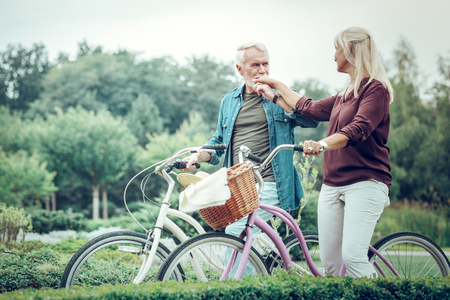 Loving husband. Nice bearded man kissing his wifes hand while expressing his love to herの写真素材