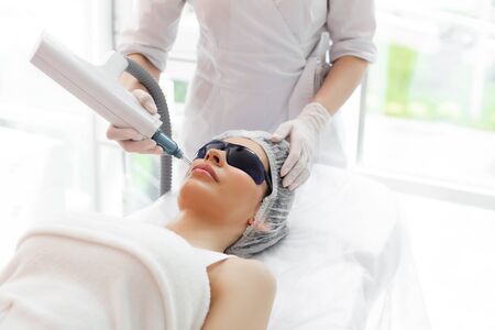 Cosmetology procedures. Special equipment being used in cosmetology clinic during cosmetology proceduresの写真素材