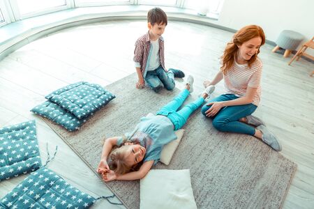 Fun in the kindergarten. Top view of children lying together on the floor while having fun in the kindergartenの写真素材