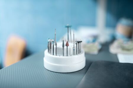 Prepared for procedures. Different tools for dental treatment standing on dentists table before using them.の写真素材