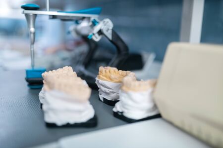 Teeth cast models. Several cast models of the teeth standing on the table with tools in working place in the office of a professional dentist.の写真素材
