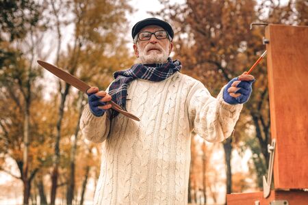 Low angle of an artist painting in park on a fine dayの写真素材
