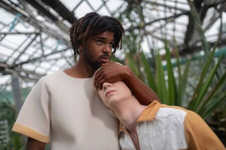 Light-skinned colleague. Dark-skinned model posing with his light-skinned colleague for magazine coverの写真素材