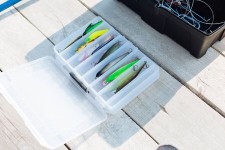 Colorful fishing hooks. Top view of colorful fishing hooks lying in special box near lakeの写真素材