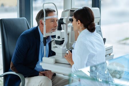 Caring for health. Nice aged man having his eyesight checked while caring for his health