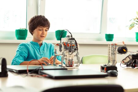 Fascinating lesson. Elementary school pupil being in raptures looking at the model he built at his...