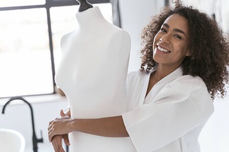 Beautiful female smiling and hugging her dress standの写真素材