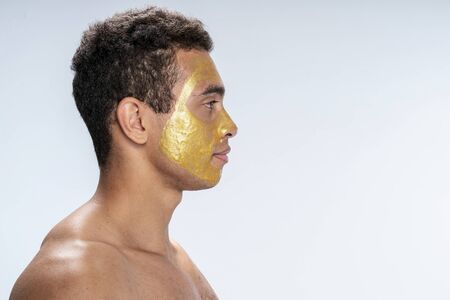 Side view of a handsome male wearing facial maskの写真素材