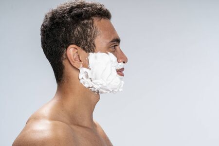 Side view of a good-looking male before his shavingの写真素材