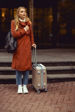 Tense young Caucasian girl waiting for a cab outdoorsの写真素材