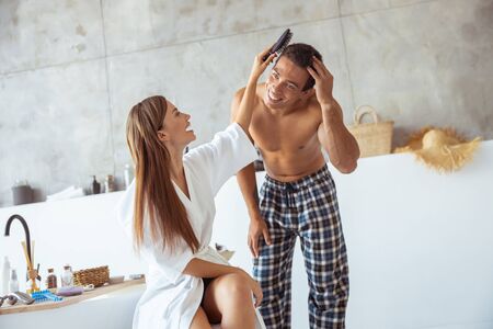 Happy together. Pretty woman laughing while having fun with her manの写真素材