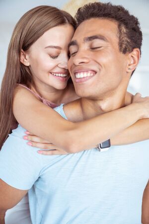 Love you. Happy international man keeping eyes closed and demonstrating his smile