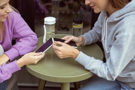 Online chat. Close up of pretty female that bowing head while reading message