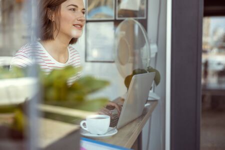 Have idea. Close up of delighted girl that looking forward while being deep in thoughts