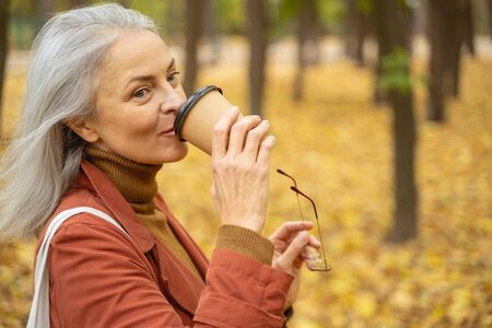 Closeup portrait of a modern woman drinking a cup of coffee