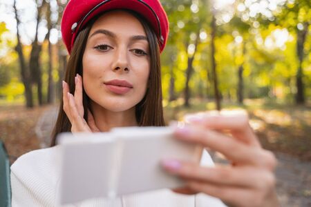 Love it. Charming female person expressing positivity while spending time in the parkの写真素材