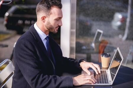 Attentive bearded male person expressing positivity while typing message
