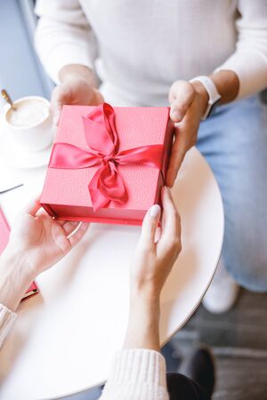 Express your love. Relaxed loving couple sitting in cafe while having dateの写真素材