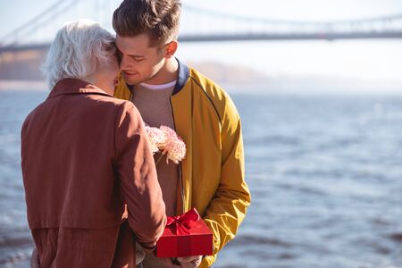 Beautiful young lady putting her head on the shoulder of her boyfriendの写真素材