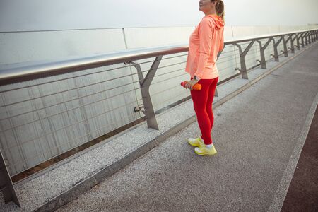Young woman in sportswear holding bottle of water stock photo