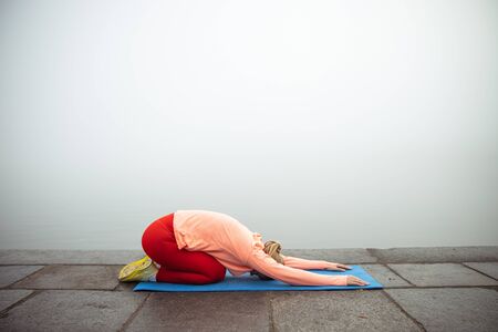 Lady practicing yoga on the street stock photo. Website bannerの写真素材
