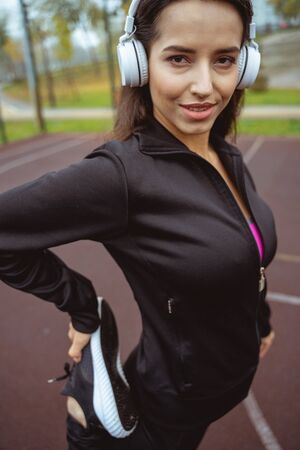 Strong body. Pretty female keeping smile on her face while doing sportの写真素材