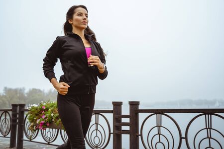 Big target. Concentrated young female looking forward while doing sport alone