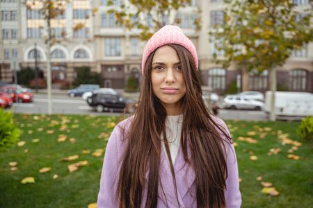 Young long haired woman pressing lips while willing to go home