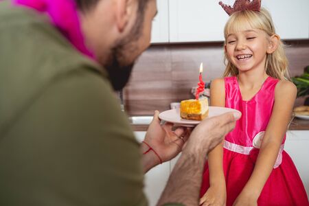 Happy little girl celebrating birthday with father stock photoの写真素材