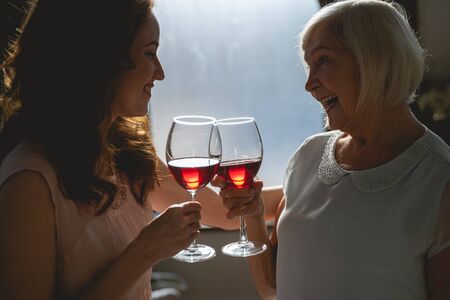 Cheerful blonde woman expressing positivity while touching glassesの写真素材