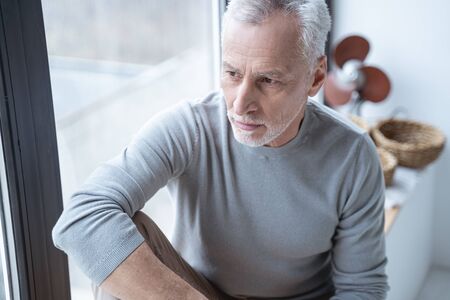 Portrait of a thoughtful adult person looking into the distance
