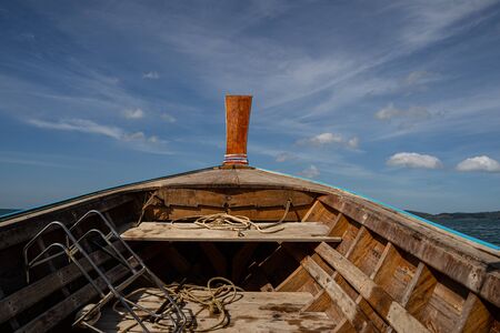 Wooden boat being on water, going to fishの写真素材