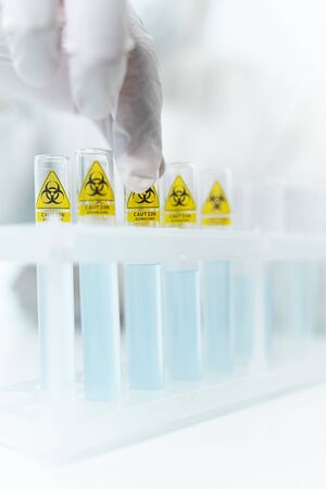 Sterile medical equipment. Professional researcher wearing rubber gloves while working at invention of antiviral vaccineの写真素材