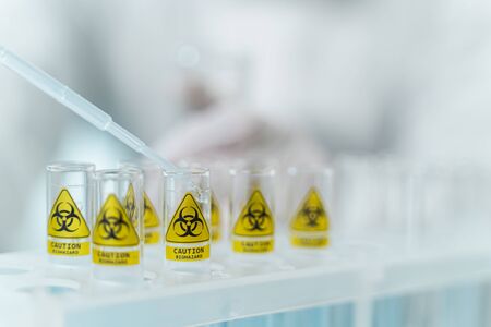 Modern laboratory. Plastic support standing on the table, professional researcher working at antiviral vaccine in labの写真素材