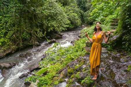 Cute young female keeping smile on her face while enjoying her vacationの写真素材