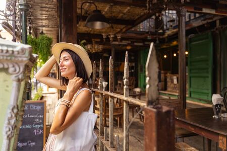Cheerful female is travelling to exotic country and walking beside restaurant in street. Website bannerの写真素材