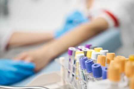 Try to relax. Silhouette of worried patient that visiting doctor, doing checkup of bloodの写真素材