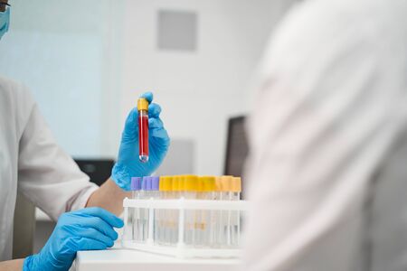Professional consultation. Competent researcher wearing protective uniform while working in modern...