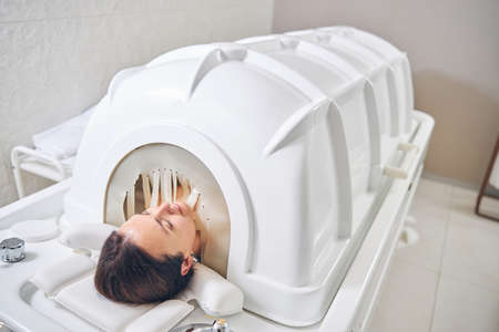 Head of woman seen from the spa capsule. Body treatment with modern technologiesの写真素材